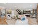 Cozy living room boasts recessed lighting, a staircase, and a view of the updated kitchen at 10114 Meade Ct, Westminster, CO 80031