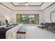 Bright main bedroom with a ceiling fan, a large window and an upholstered bench at the foot of the bed at 10114 Meade Ct, Westminster, CO 80031