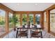 Bright sunroom with wood paneled walls, patterned floors, and views of the backyard at 10114 Meade Ct, Westminster, CO 80031