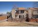 Exterior shot of the home's back showing a patio with the sliding glass door to the inside at 15393 E Louisiana Ave, Aurora, CO 80017