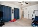 Spacious bedroom featuring two closets with dark blue curtains, large windows and ceiling fan at 15393 E Louisiana Ave, Aurora, CO 80017