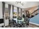 Dining area with a glass table, designer chairs, and windows offering bright light with access to outdoor living at 15393 E Louisiana Ave, Aurora, CO 80017