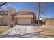 Charming two-story home featuring a spacious driveway, a two car garage and classic brick and siding details at 15393 E Louisiana Ave, Aurora, CO 80017