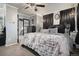 Inviting primary bedroom with a luxe faux fur throw, dark wood accents, and a glimpse of the staircase at 15393 E Louisiana Ave, Aurora, CO 80017