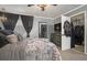 Comfortable bedroom with plush bedding, full-length mirror, and ample closet space for an organized wardrobe at 15393 E Louisiana Ave, Aurora, CO 80017