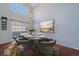 Dining room with large windows, modern chandelier, and an elegant dining set at 6820 W 84Th Cir # 25, Arvada, CO 80003