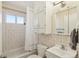 Cozy bathroom features tiled walls, a shower with tub, and a vanity with mirrored cabinet at 9271 Gaylord St, Thornton, CO 80229