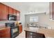 Well-lit kitchen features wooden cabinets, granite countertops, and a cozy dining area at 9271 Gaylord St, Thornton, CO 80229