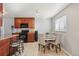 Kitchen and dining area featuring dark cabinetry, granite countertops, and stainless steel appliances at 9271 Gaylord St, Thornton, CO 80229