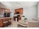 Well-lit kitchen and dining area with hardwood floors, dark cabinets, and modern appliances at 9271 Gaylord St, Thornton, CO 80229