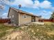 A partial view of the home's backyard showcasing a concrete patio and the home's exterior at 381 Freestone St, Brighton, CO 80603