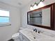 Updated bathroom features a marble vanity, modern fixtures, and a large framed mirror at 381 Freestone St, Brighton, CO 80603