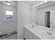 Bright bathroom featuring double sinks, a large mirror and great natural light at 381 Freestone St, Brighton, CO 80603