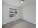 Neutral bedroom features bright white walls, carpet, and a large window at 381 Freestone St, Brighton, CO 80603