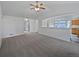 Spacious living room featuring neutral carpet, bright white walls, and a ceiling fan at 381 Freestone St, Brighton, CO 80603