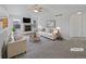 Bright living room featuring a fireplace, ceiling fan, neutral paint, and plenty of natural light at 381 Freestone St, Brighton, CO 80603