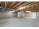 Unfinished basement with exposed beams, concrete foundation, and window offering natural light at 1507 Alpine Ave, Berthoud, CO 80513