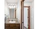Cozy bathroom with wood vanity, vessel sink, tile floors, and a large framed mirror above the sink at 1507 Alpine Ave, Berthoud, CO 80513