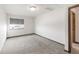 Bright bedroom featuring neutral carpet, a window with blinds, and fresh paint at 1507 Alpine Ave, Berthoud, CO 80513