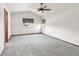 Spacious bedroom with vaulted ceiling, ceiling fan, gray carpet, and two windows at 1507 Alpine Ave, Berthoud, CO 80513