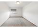 Bright bedroom featuring neutral carpet, a window with blinds, and fresh paint at 1507 Alpine Ave, Berthoud, CO 80513