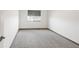 Bright bedroom featuring neutral carpet, a window with blinds, and fresh paint at 1507 Alpine Ave, Berthoud, CO 80513