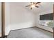 Neutral bedroom featuring gray carpet, window, and a ceiling fan at 1507 Alpine Ave, Berthoud, CO 80513