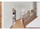 Bright foyer featuring hardwood floors, staircase, and doorway leading to other rooms at 1507 Alpine Ave, Berthoud, CO 80513