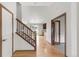 Open-concept foyer with hardwood flooring and staircase, offering a glimpse of the kitchen at 1507 Alpine Ave, Berthoud, CO 80513