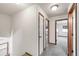 Bright hallway features neutral walls, gray carpet, and wood trim accents around the doors at 1507 Alpine Ave, Berthoud, CO 80513