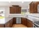 Renovated kitchen showcasing granite counters, stainless appliances, mosaic backsplash, wood cabinets, and hardwood floors at 1507 Alpine Ave, Berthoud, CO 80513