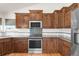 Charming kitchen featuring granite countertops, stainless steel appliances, wood cabinets, and light hardwood floors at 1507 Alpine Ave, Berthoud, CO 80513