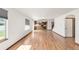 Open-concept living room with hardwood floors, offering views of the kitchen and backyard at 1507 Alpine Ave, Berthoud, CO 80513