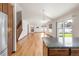 Open concept living room featuring hardwood floors, a fireplace, and large windows for ample natural light at 1507 Alpine Ave, Berthoud, CO 80513
