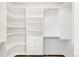 Walk-in closet featuring custom shelving and drawer units at 1507 Alpine Ave, Berthoud, CO 80513