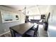 Spacious dining room with table, mirror, chandelier, and a seamless transition into the cozy living room at 8209 Balsam Way, Arvada, CO 80005