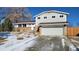 Charming two-story home with a two-car garage, brick accents and a well-manicured front yard at 8209 Balsam Way, Arvada, CO 80005