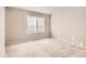 Neutral-toned bedroom with carpet flooring and window with blinds at 6448 Silver Mesa Dr # B, Highlands Ranch, CO 80130