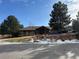 Community clubhouse with ample parking and landscaping at 6448 Silver Mesa Dr # B, Highlands Ranch, CO 80130