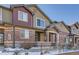 Brick townhouse exterior with a small front yard and metal fence at 6448 Silver Mesa Dr # B, Highlands Ranch, CO 80130