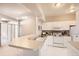 Open kitchen with white cabinets, breakfast bar, and access to patio at 6448 Silver Mesa Dr # B, Highlands Ranch, CO 80130