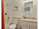 Clean, bright bathroom featuring a shower-tub combo, modern fixtures, and open shelf at 4820 W 13 Ave, Denver, CO 80204