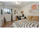Cozy bedroom offers a comfortable workspace area, with ample natural light and neutral decor at 4820 W 13 Ave, Denver, CO 80204
