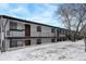 Exterior view of a multi-unit building with balconies and snow-covered ground at 4820 W 13 Ave, Denver, CO 80204