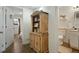 Hallway view with decorative cabinet between living area and remodeled bathroom at 4820 W 13 Ave, Denver, CO 80204