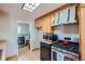 Kitchen with gas stove, microwave, and laundry area just off the kitchen at 1871 Teller St, Lakewood, CO 80214