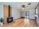 Bright living room with wood floors, wood-burning stove, and sliding door to patio at 1871 Teller St, Lakewood, CO 80214