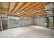 Unfinished basement featuring a window and utilities at 6973 W Louisiana Ave # E, Denver, CO 80232