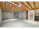 Unfinished basement with open ceiling and concrete floor at 6973 W Louisiana Ave # E, Denver, CO 80232