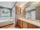 Bathroom featuring a shower, tub, wood-look flooring, and a double sink vanity at 6973 W Louisiana Ave # E, Denver, CO 80232